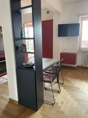 a kitchen with a table and a chair in a room at la casa di Janis in Rome