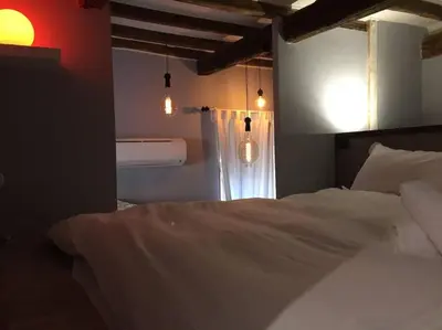 a bedroom with a bed and a window with lights at The 150 Home - Homkeey Apartments in Rome