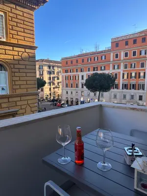 a living room with a couch and a table at Monolocale San Giovanni con Balcone a 50 m dalla metro in Rome