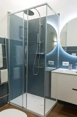 a shower with a glass door in a bathroom at 2-Bedroom Roman Gem in Rome