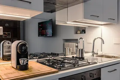 a kitchen with a coffee maker on a counter at 2-Bedroom Roman Gem in Rome