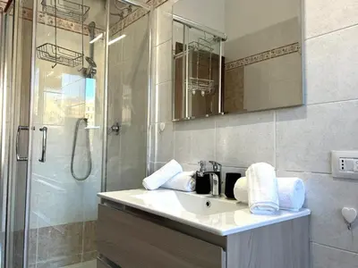 a bathroom with a sink and a shower at Triade Home in Rome