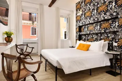 a bedroom with a bed with a black and yellow patterned wall at Palazzo Tridente Rooms in Rome