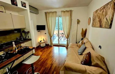 a living room with a couch and a wooden floor at Dream Home Cortina in Rome