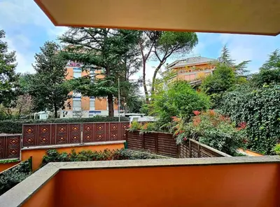 a view of a garden from the balcony of a house at Dream Home Cortina in Rome