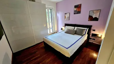a bedroom with a large bed with purple walls at Dream Home Cortina in Rome