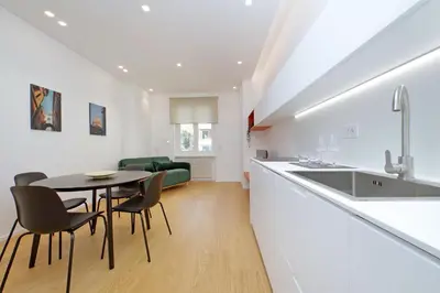 a kitchen and dining room with a table and chairs at 4BNB - Charming Giuliana Apartment in Rome