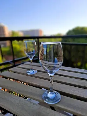 two wine glasses sitting on top of a wooden table at Locazione turistica di Alberto in Rome