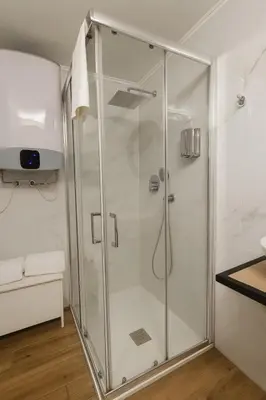 a shower with a glass door in a bathroom at éROMA - NAVONA Apartment in Rome