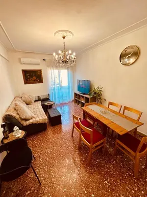 a living room with a table and a couch at Aurelio Vatican Apartment in Rome