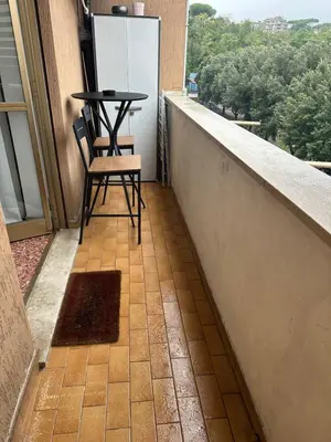 a balcony with a table and two chairs on it at Aurelio Vatican Apartment in Rome