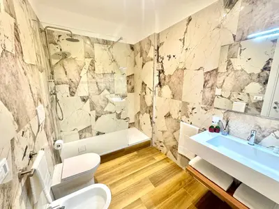 a bathroom with a toilet and a sink and a tub at Saint Peter Rome - Luxury Apartments with 24H Guarded Parking in Rome