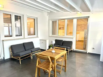 a living room with two chairs and a table at Saint Peter Rome - Luxury Apartments with 24H Guarded Parking in Rome