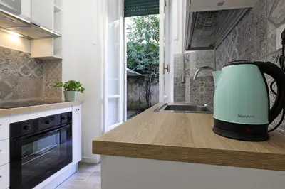 a kitchen with a white appliance on a counter at Bologna GARDEN HOUSE in Rome
