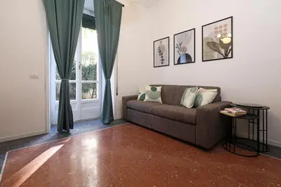a living room with a couch and a window at Bologna GARDEN HOUSE in Rome
