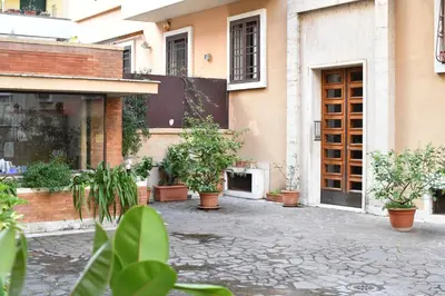 a courtyard with potted plants in front of a building at BFabretti5 in Rome