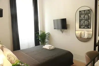a bedroom with a bed and a mirror at Giulio Cesare Comfort Rooms in Rome