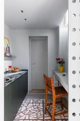 a kitchen with a wooden chair and a table at ATEL Relais in Rome