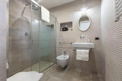 a bathroom with a shower and a toilet and a sink at Exclusive House Ghetto in Rome