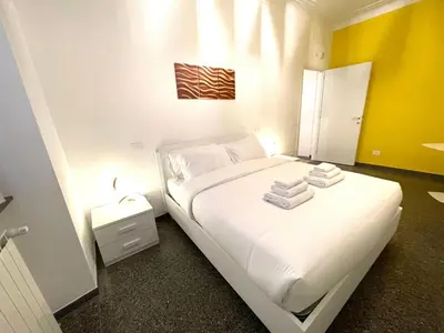 a bedroom with a white bed with towels on it at Royal Golden House in Rome