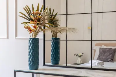 two blue vases sitting on a table with flowers at iFlat Stylish & Cozy apt in the Heart of Monti in Rome