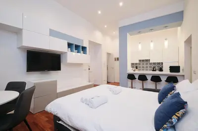 a bedroom with a bed and a table and chairs at Castel Sant'Angelo - Elegant flat in Rome Centre in Rome