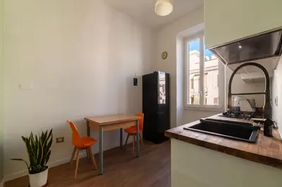 a kitchen with a sink and a table and a counter at GuestHost - Roma San Lorenzo Apartment in Rome