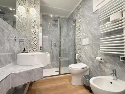 a bathroom with a toilet and a sink and a shower at Villa Angela in Rome