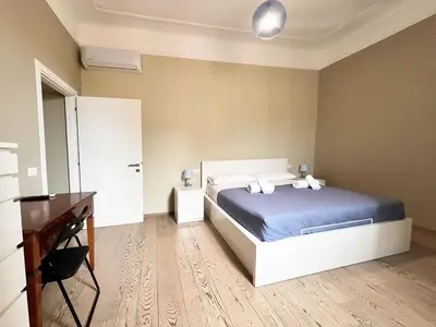 a bedroom with a bed and a dresser and a desk at La Casa Di Piero in Via Ottaviano in Rome