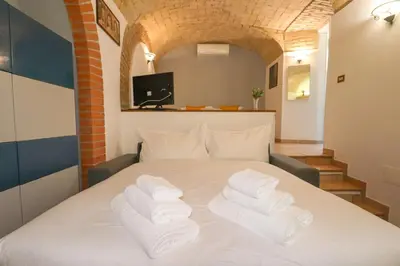 a bedroom with a bed with towels on it at Authentic Central Roman Home - Metro 7min, 5min to Rome Center, AC, Wi-Fi in Rome