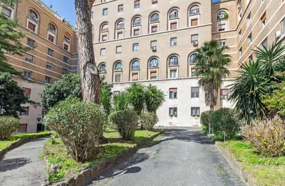 an empty street in front of a large building at Blu Colombo in Rome