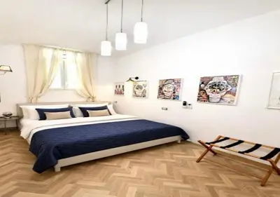 a bedroom with a large bed with a blue blanket at Vatican Prestige Suite 