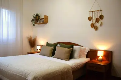 a bedroom with a large bed with two lamps at Attico Aurelia Antica in Rome