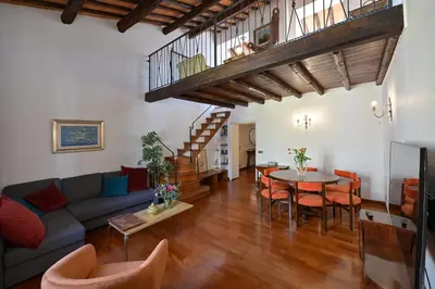 a living room with a couch and a table and chairs at Domus Greci Piazza di Spagna in Rome