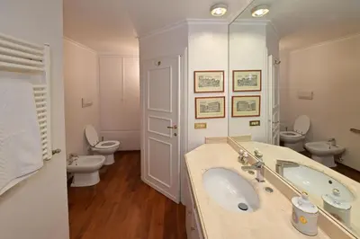 a bathroom with a sink and two toilets at Domus Greci Piazza di Spagna in Rome