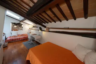 a bedroom with an orange bed and a desk at Domus Greci Piazza di Spagna in Rome