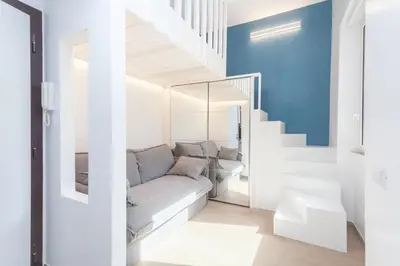 a living room with a couch and stairs at Rhome Vatican Chic in Rome