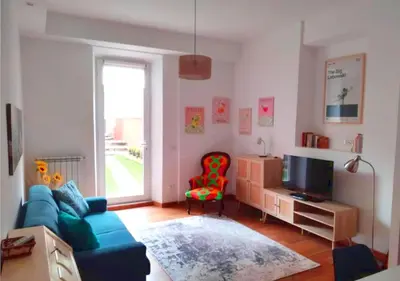 a living room with a blue couch and a red chair at Casita in Rome