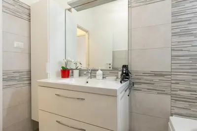 a white bathroom with a sink and a shower at Roma Big terrace Home in Rome
