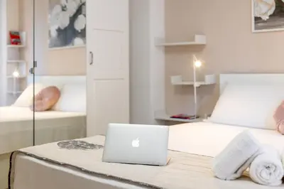 a laptop computer sitting on a table in a bedroom at Roma Big terrace Home in Rome