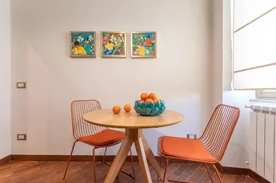 a table with two chairs and a bowl of fruit on it at YCH-Unique apartment near Vatican in Rome
