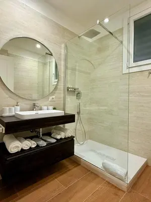 a bathroom with a shower and a sink and a mirror at Sweet Life Monteverde in Rome
