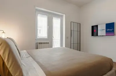 a bedroom with a bed with two towels on it at San Lorenzo Home in Rome