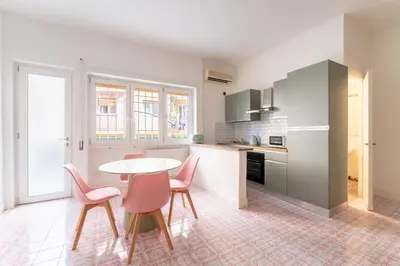 a kitchen with a table and chairs in a room at Retrò Loft Ponte Milvio, Nearby Foro Italico in Rome