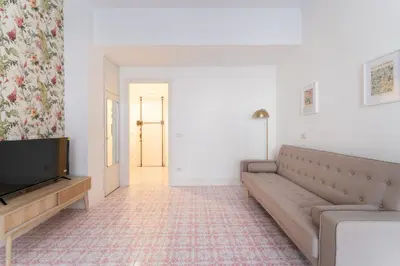 a living room with a couch and a flat screen tv at Retrò Loft Ponte Milvio, Nearby Foro Italico in Rome