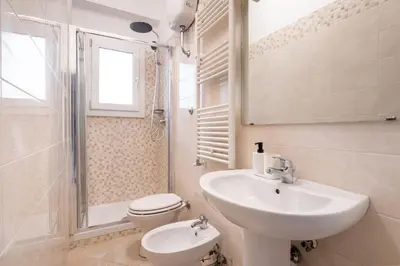 a white bathroom with a sink and a toilet at Retrò Loft Ponte Milvio, Nearby Foro Italico in Rome