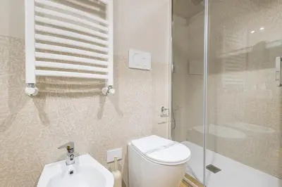 a bathroom with a toilet and a shower and a sink at Boutique Atrium Pantheon in Rome