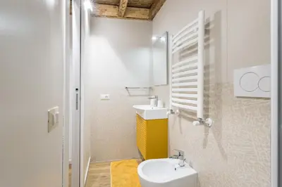 a bathroom with a white toilet and a sink at Boutique Atrium Pantheon in Rome
