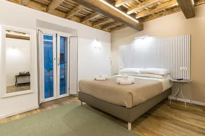 a bedroom with a bed with towels on it at Boutique Atrium Pantheon in Rome