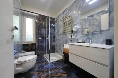 a bathroom with a toilet and a sink and a shower at Vatican Rooms Mura Aurelie in Rome